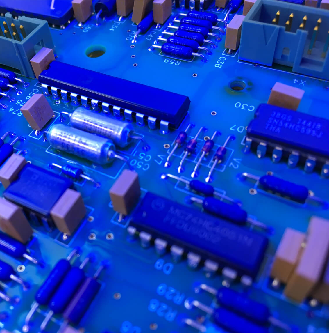 Rapier Electronics Adelaide - printed circuit board parts pic a circuit board under a blue light inspection